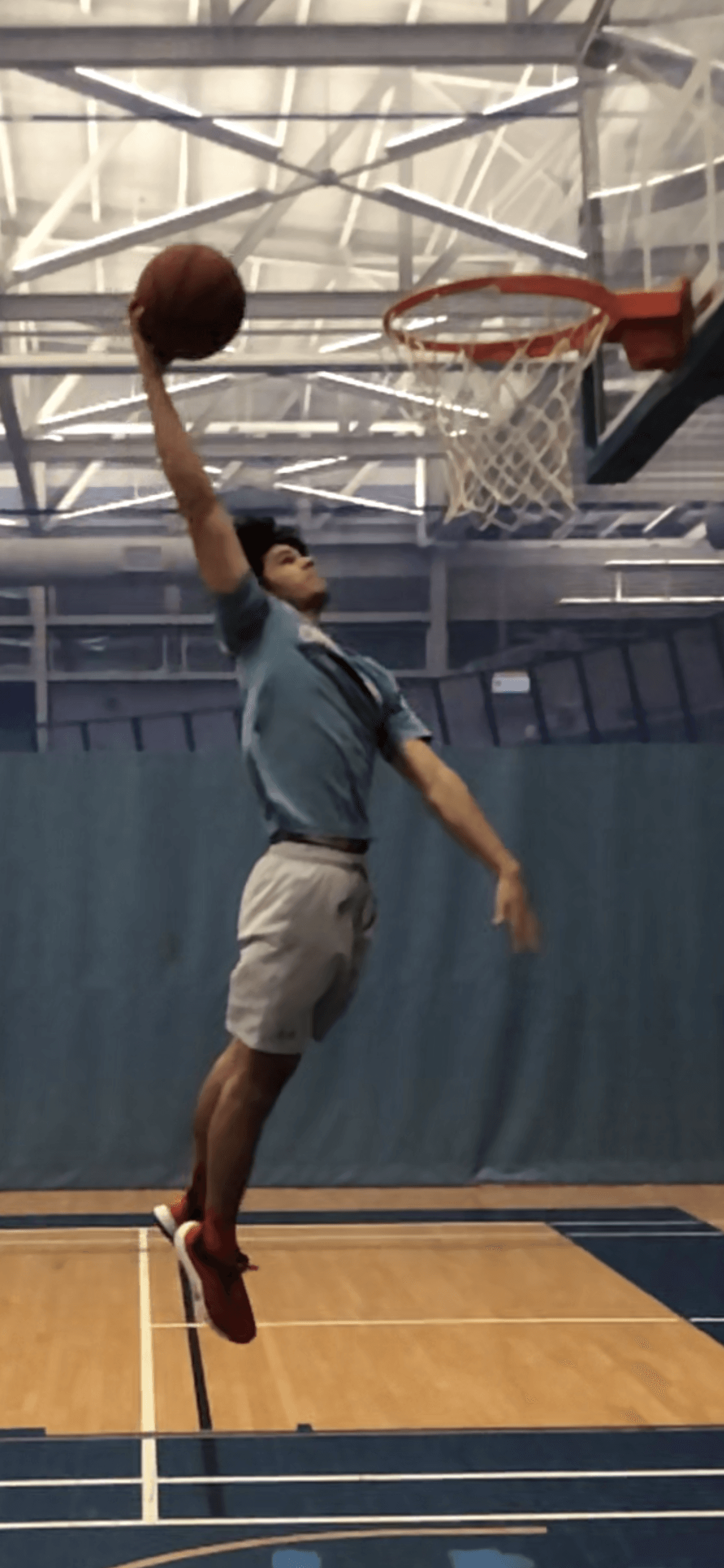 Thomas Musial dunking a basketball